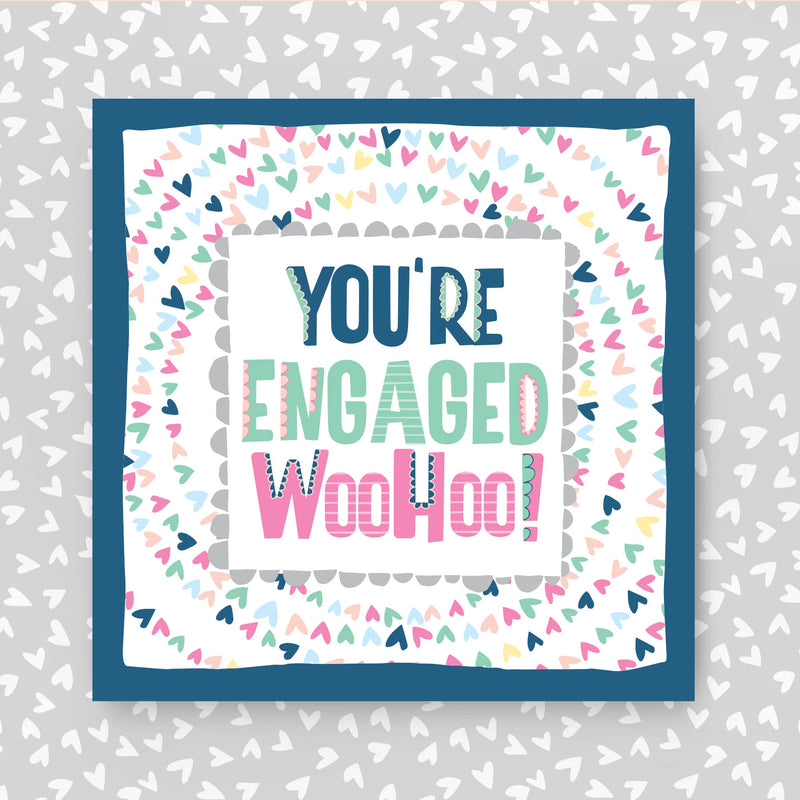 Card with 'You're Engaged WooHoo!' text on a heart-patterned background. Perfect to celebrate an engagement